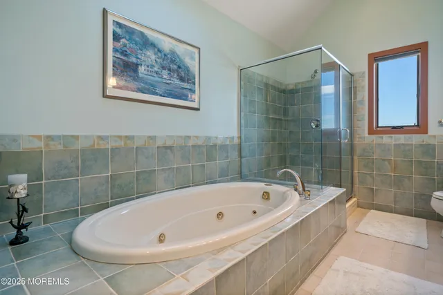 a white bath tub sitting next to a small bathroom