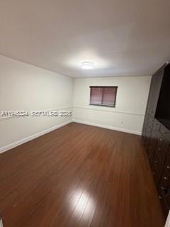 3011 West 76th Street, Unit A208 Hialeah, FL 33018 - Photo 7 of 14 an empty room with wooden floor and windows