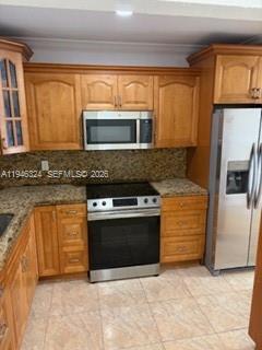 3011 West 76th Street, Unit A208 Hialeah, FL 33018 - Photo 9 of 14 a kitchen with stainless steel appliances granite countertop a stove microwave and refrigerator