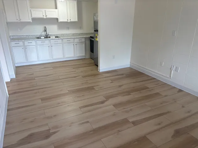 a view of a kitchen with wooden floor