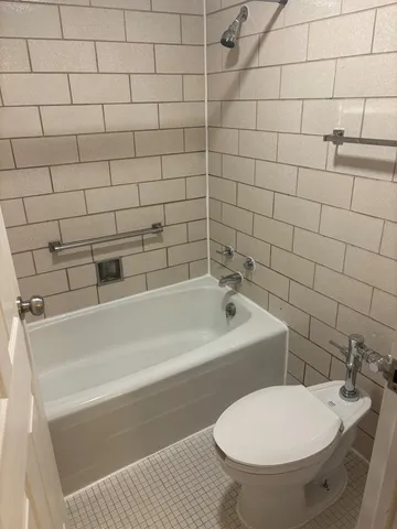 a bathroom with a bathtub and a toilet