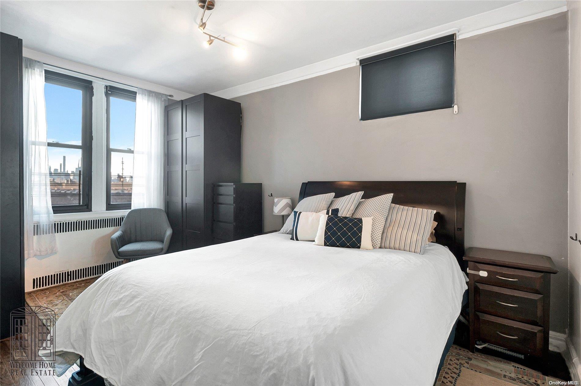 41-42 50th Street, Unit 4E Queens, NY 11377 - Photo 6 of 11 a bedroom with a large bed and a tv