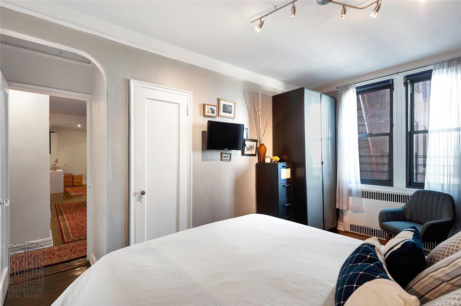 41-42 50th Street, Unit 4E Queens, NY 11377 - Photo 7 of 11 a bedroom with a bed and wooden floor