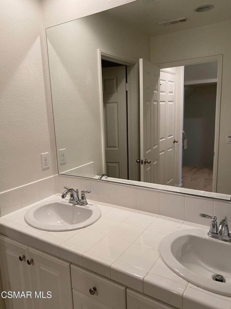 2234 Rolling River Lane, Unit 3 Simi Valley, CA 93063 - Photo 8 of 13 a bathroom with a sink and a mirror