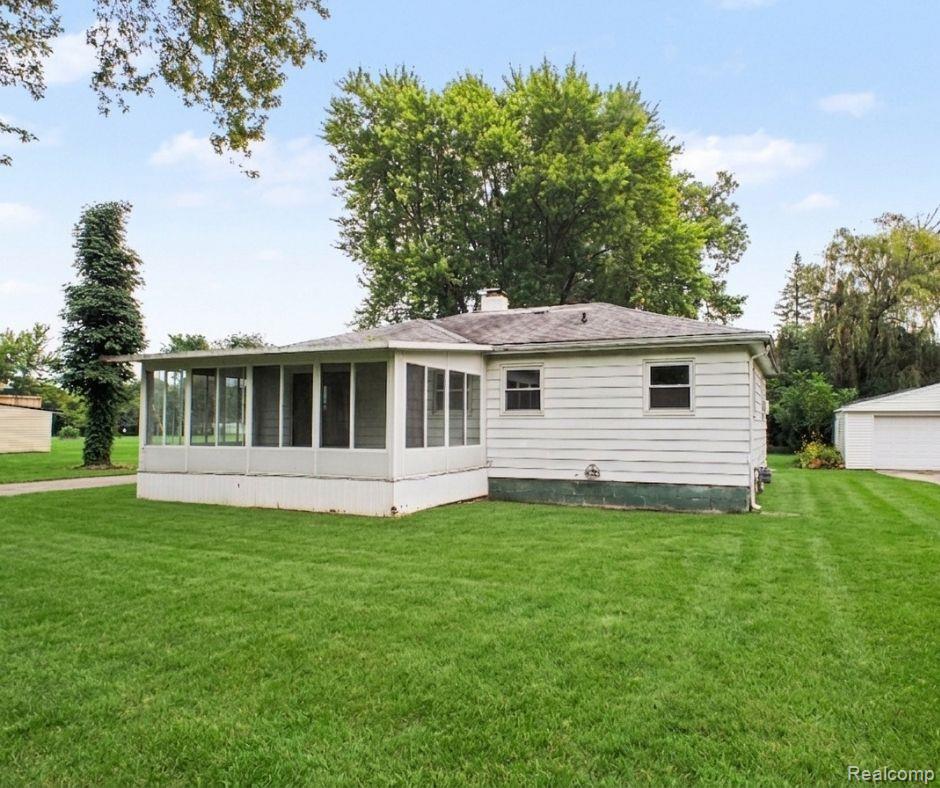 5082 North Center Road Flint, MI 48506 - Photo 9 of 21 Expansive lawn surrounds the residence, featuring a screened-in porch and detached garage