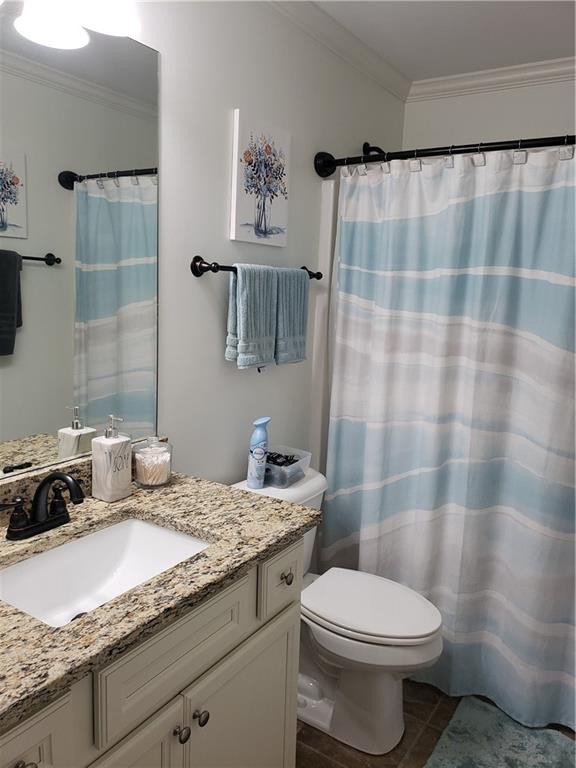 108 Millers Lane Calhoun, GA 30701 - Photo 15 of 21 a bathroom with a granite countertop sink a toilet and a shower curtain