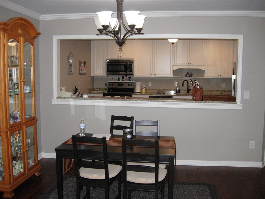 108 Millers Lane Calhoun, GA 30701 - Photo 4 of 21 a kitchen with stainless steel appliances a sink a stove a table and chairs
