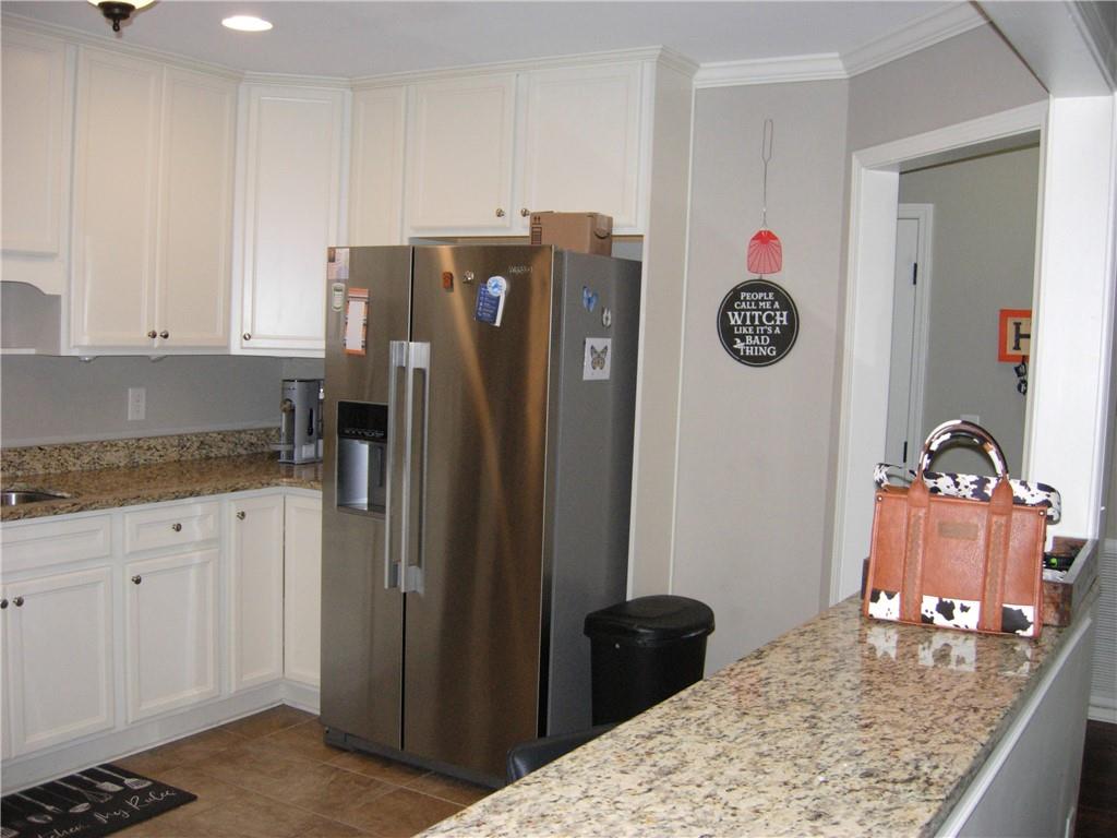 108 Millers Lane Calhoun, GA 30701 - Photo 8 of 21 a kitchen with a refrigerator and a stove top oven