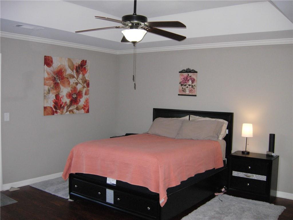 108 Millers Lane Calhoun, GA 30701 - Photo 10 of 21 a bedroom with a bed and a chandelier