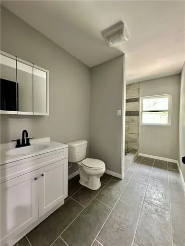 a bathroom with a toilet sink and a mirror