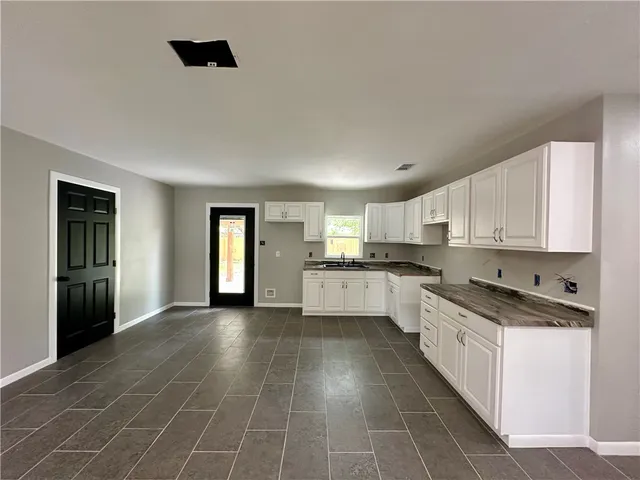 a kitchen with stainless steel appliances granite countertop a sink and cabinets