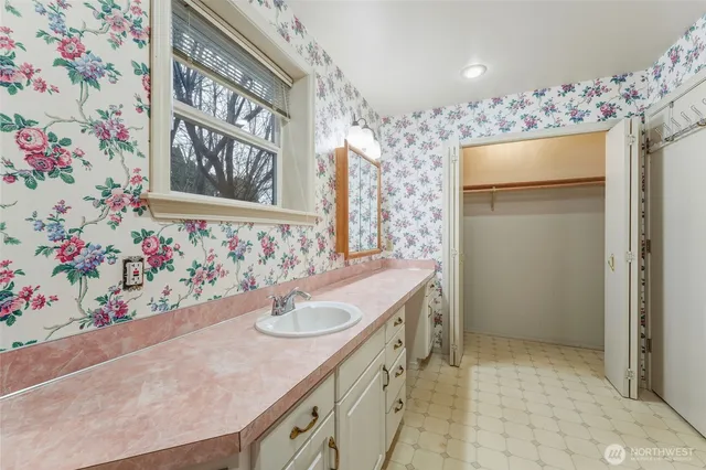 a bathroom with a sink and mirror