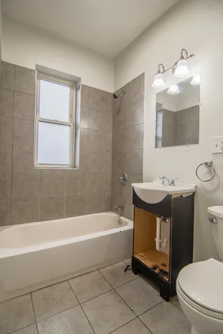 a bathroom with a sink a toilet and bathtub