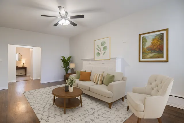 a living room with furniture and a potted plant