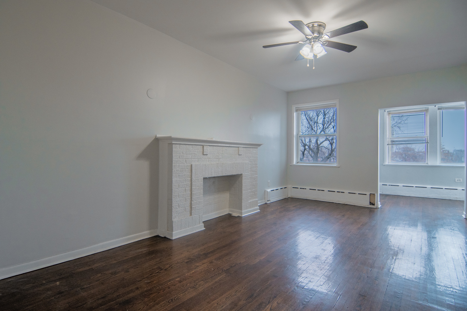 310 South Springfield Avenue, Unit 2S Chicago, IL 60624 - Photo 3 of 15 a view of empty room with wooden floor and fan