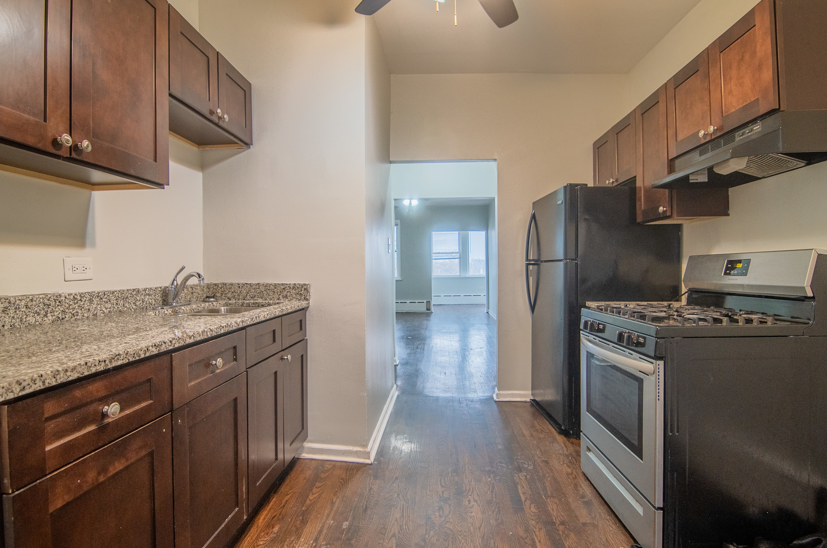 310 South Springfield Avenue, Unit 2S Chicago, IL 60624 - Photo 7 of 15 a kitchen with stainless steel appliances granite countertop a stove a sink dishwasher and a refrigerator