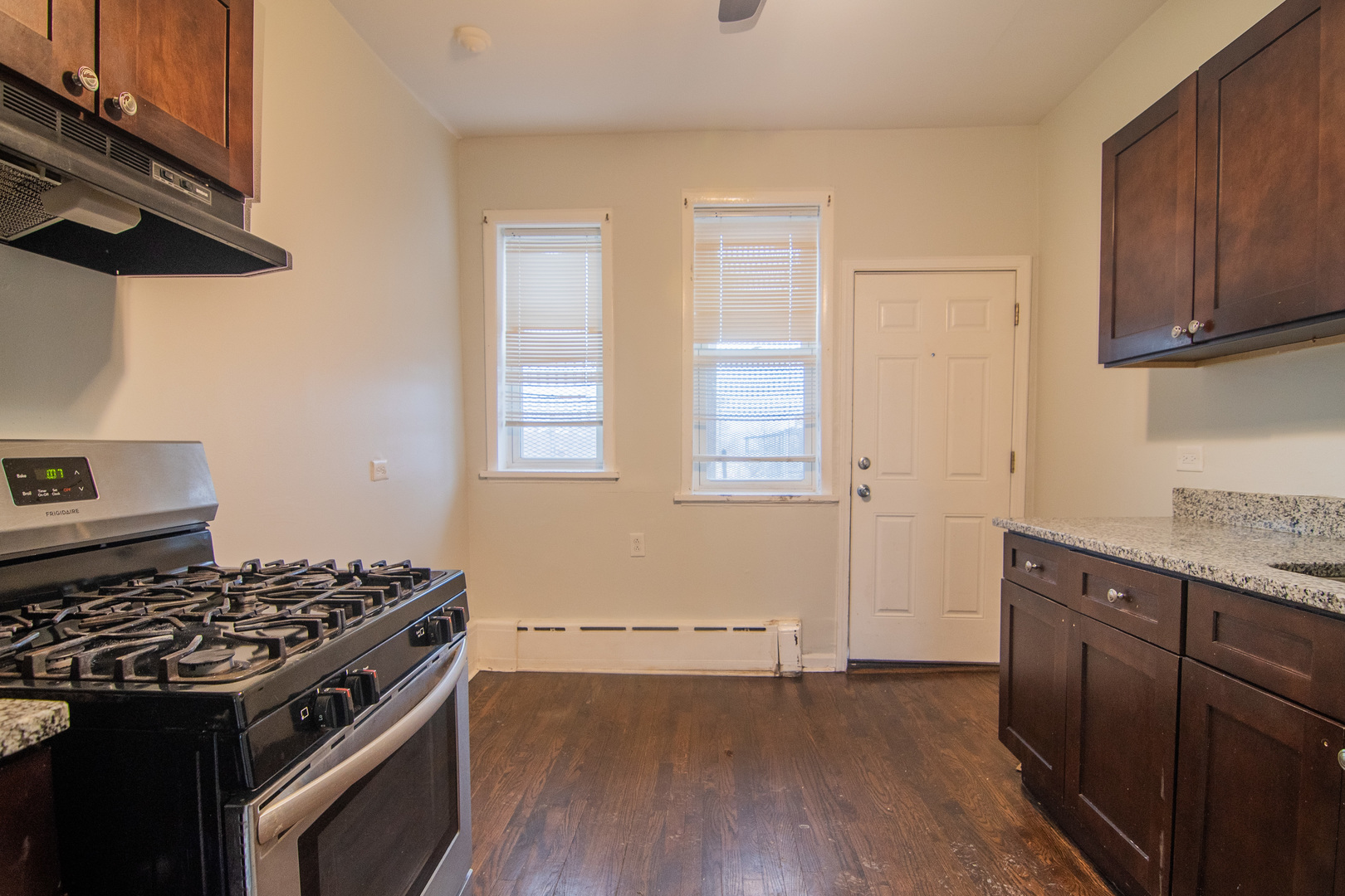 310 South Springfield Avenue, Unit 2S Chicago, IL 60624 - Photo 8 of 15 a kitchen with wooden floor and a stove top oven