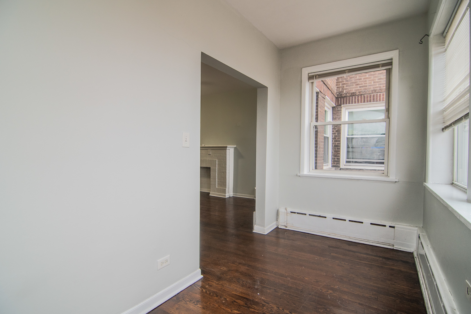 310 South Springfield Avenue, Unit 2S Chicago, IL 60624 - Photo 9 of 15 a view of an empty room with wooden floor and a window