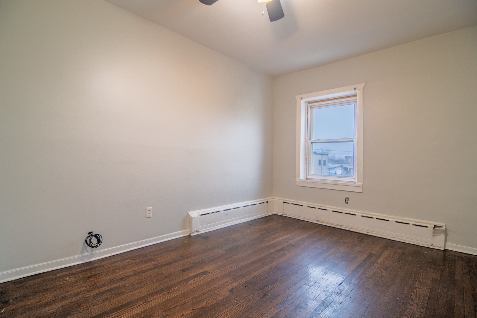 310 South Springfield Avenue, Unit 2S Chicago, IL 60624 - Photo 10 of 15 an empty room with wooden floor and windows