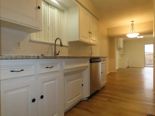 a kitchen with a sink and cabinets