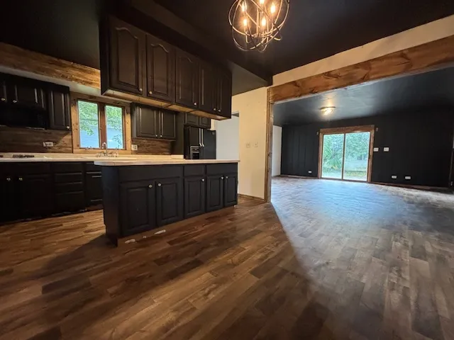 a kitchen with wooden cabinets and chandelier