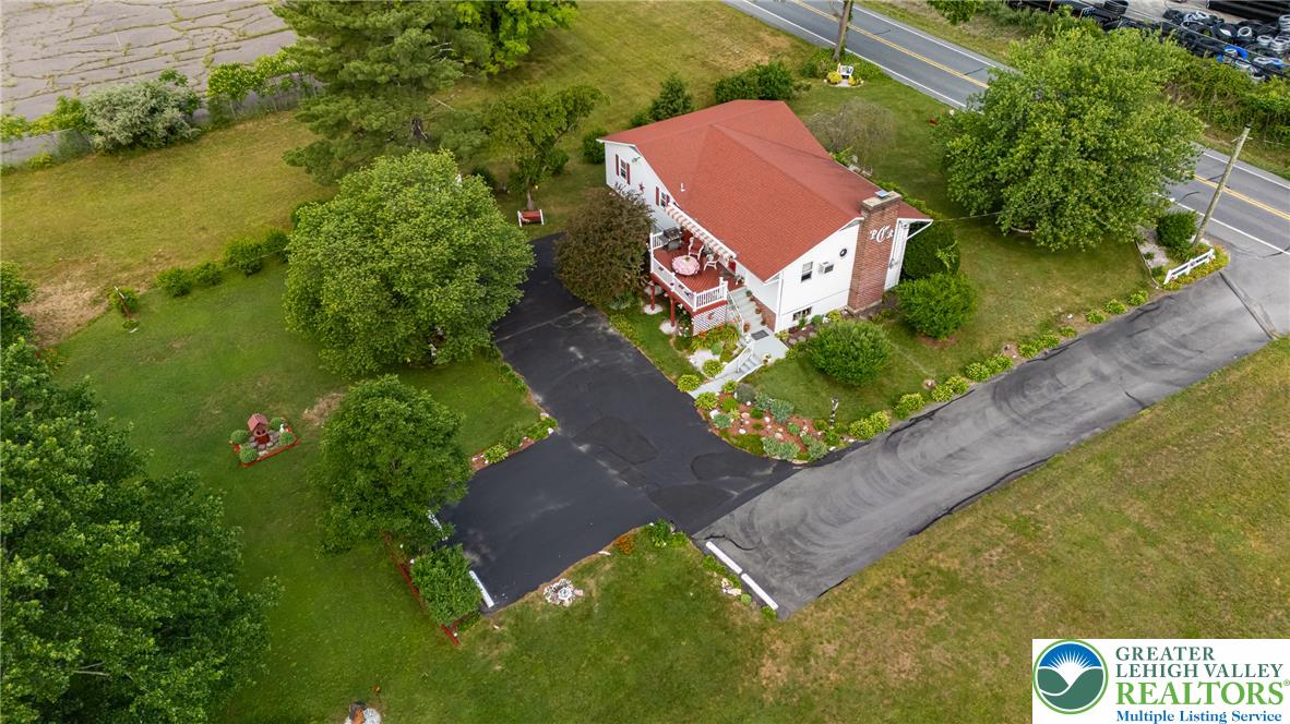 678 Interchange Road Kresgeville, PA 18333 - Photo 2 of 45 An aerial perspective reveals a charming residence nestled amidst a verdant landscape with a convenient driveway.