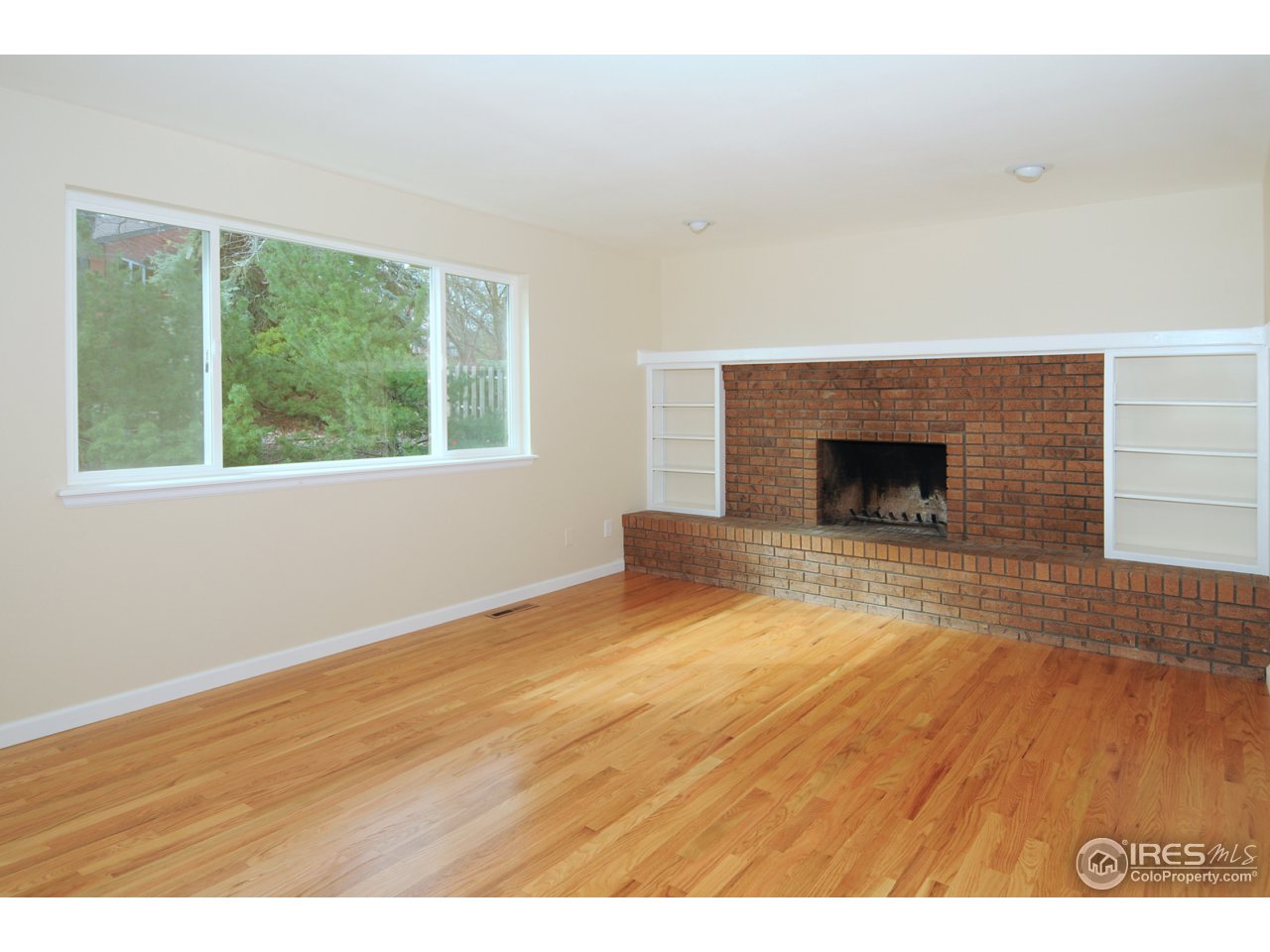 7428 Mt Sherman Road Longmont, CO 80503 - Photo 7 of 25 Family room with brick fireplace