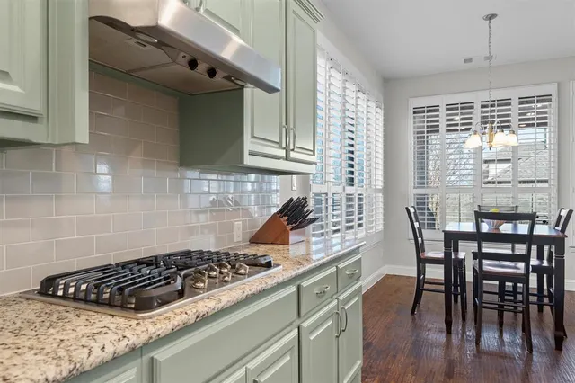 a kitchen with a table chairs and a stove