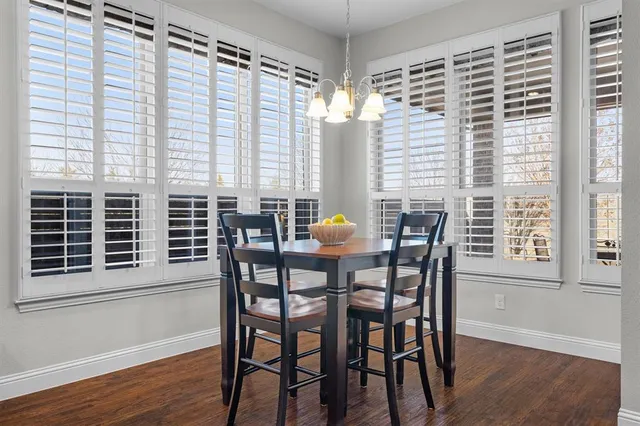 a view of a dining room with furniture and windows