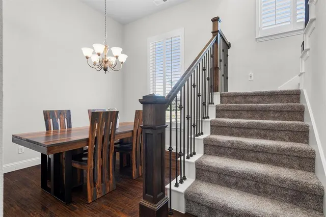 a view of a livingroom with furniture stairs wooden floor and staircase
