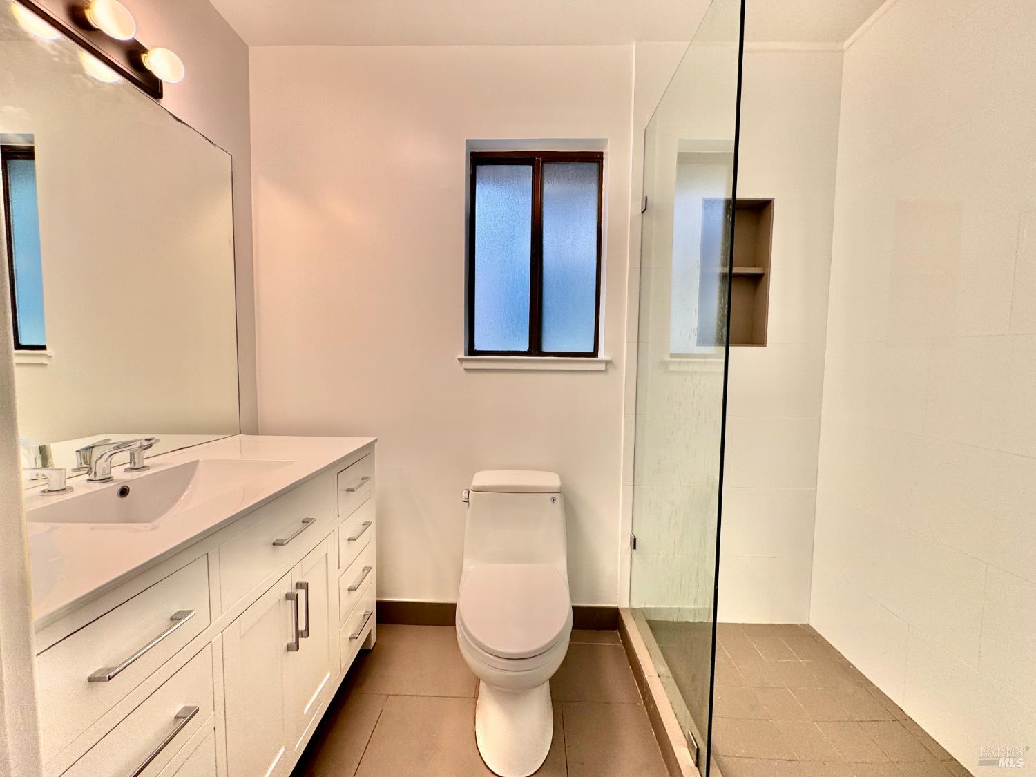 55-61 Park Road Fairfax, CA 94930 - Photo 14 of 26 a bathroom with a toilet sink and mirror