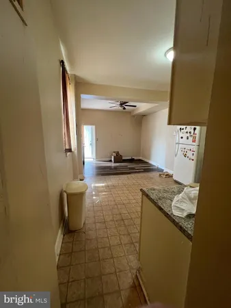 a kitchen with a sink a stove top oven and cabinetry
