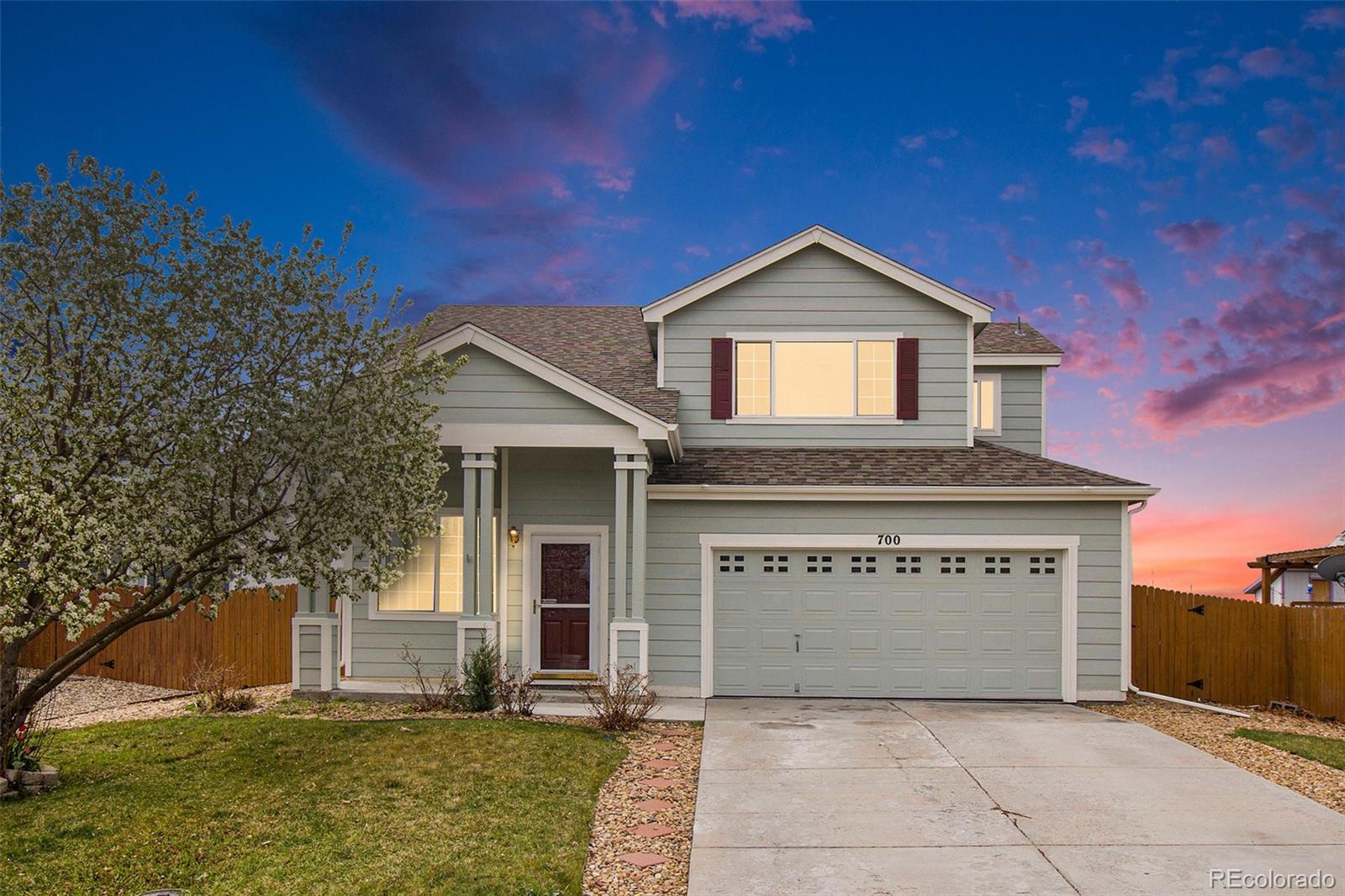 700 Elizabeth St Circle Dacono, CO 80514 - Photo 1 of 24 a view of front of house with yard and garage
