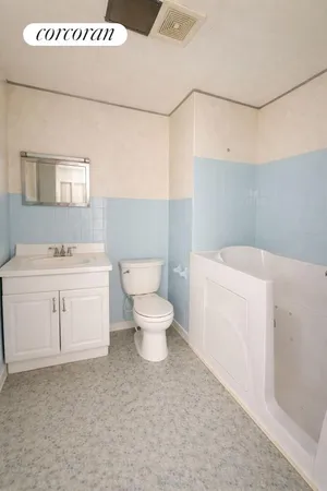 a white toilet sitting next to a bathroom sink