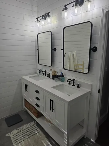 a backyard of a house with fire pit and outdoor seating