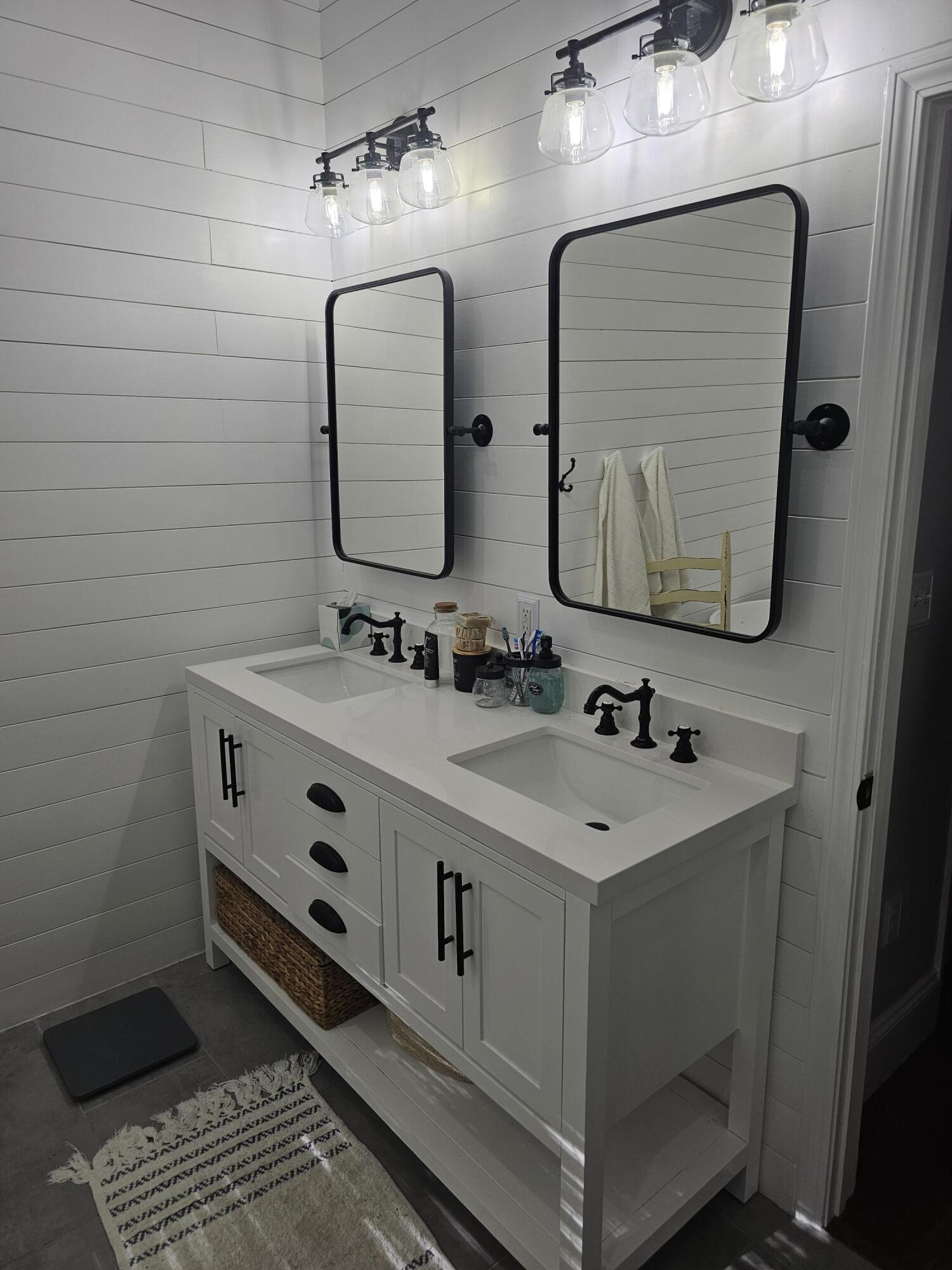 75 Evergreen Parkway DeFuniak Springs, FL 32435 - Photo 23 of 51 a bathroom with a double vanity sink and a mirror
