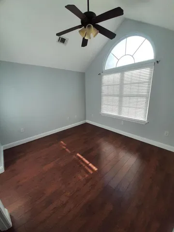 a view of a lake with boats and trees around