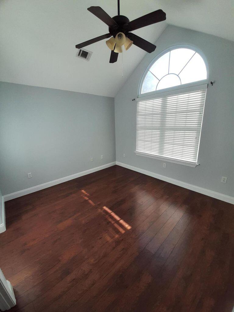 75 Evergreen Parkway DeFuniak Springs, FL 32435 - Photo 27 of 51 an empty room with wooden floor and windows