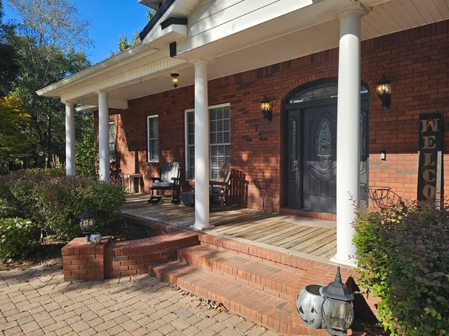 a view of a house with snow on the tree