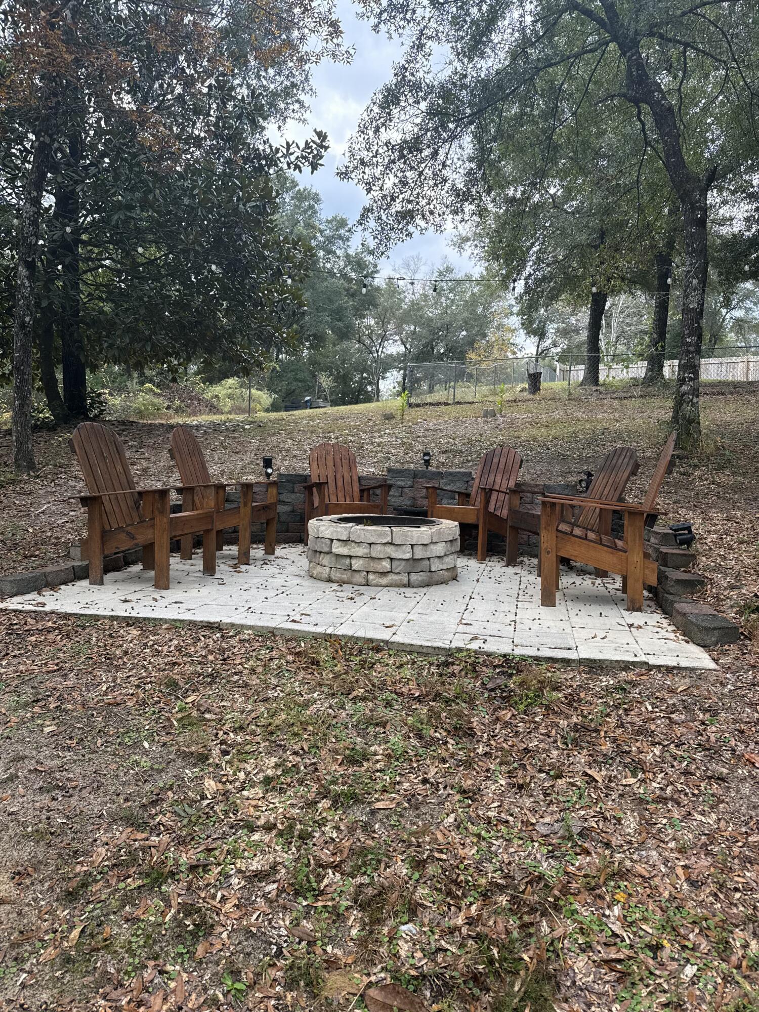 75 Evergreen Parkway DeFuniak Springs, FL 32435 - Photo 40 of 51 a backyard of a house with fire pit and outdoor seating