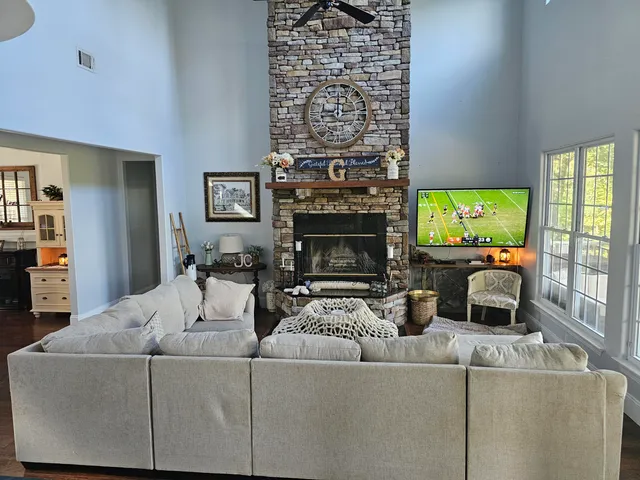 a kitchen with stainless steel appliances granite countertop a table chairs microwave and sink