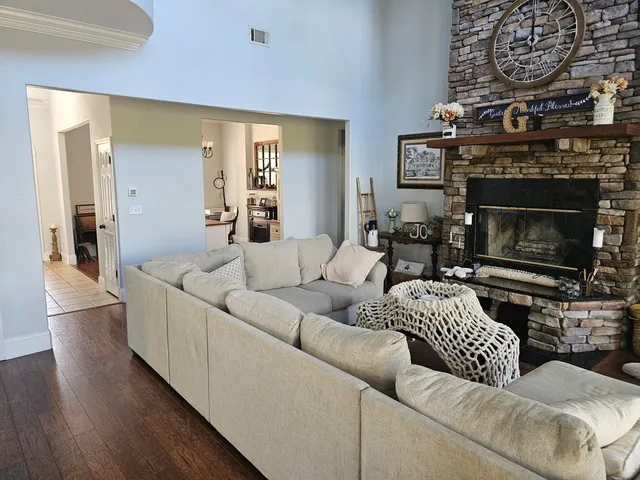 a living room with fireplace furniture and a chandelier