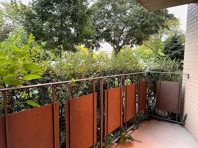 a view of a balcony with wooden fence