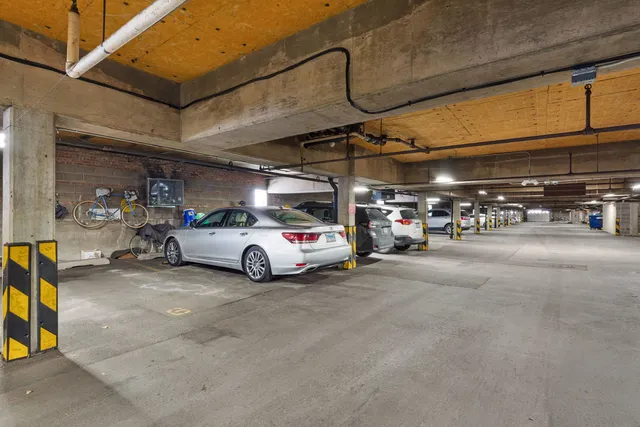 a view of parking garage with cars