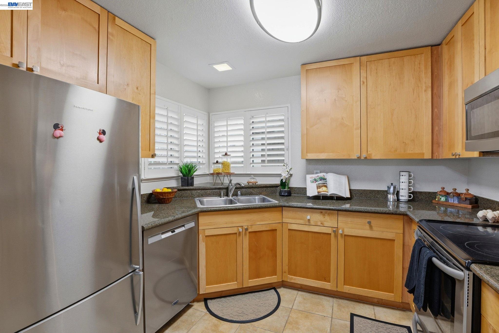 309 South Overlook Drive San Ramon, CA 94582 - Photo 6 of 29 a kitchen with stainless steel appliances granite countertop a sink a stove and a refrigerator