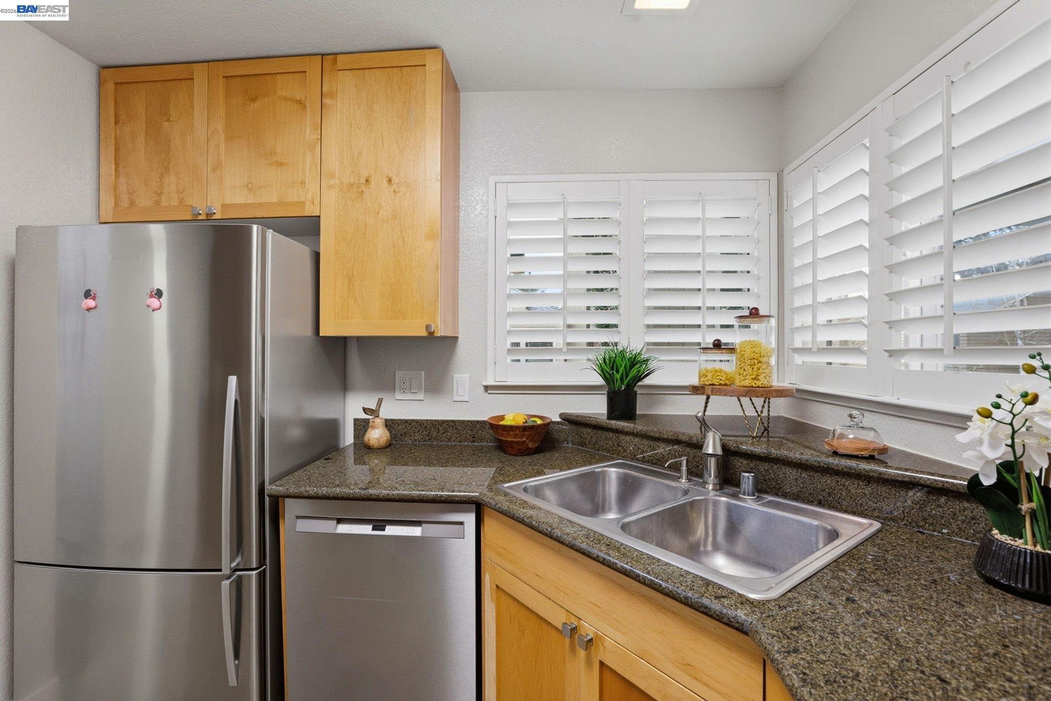 309 South Overlook Drive San Ramon, CA 94582 - Photo 7 of 29 a kitchen with a refrigerator a sink a counter space and cabinets