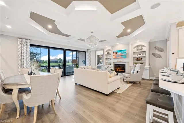a living room with fireplace furniture and a large window
