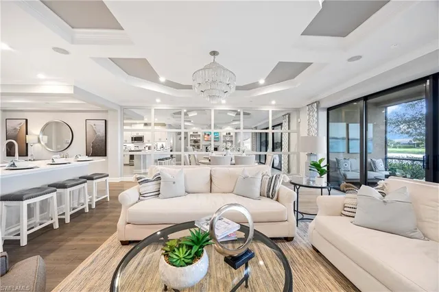 a living room with furniture and a chandelier