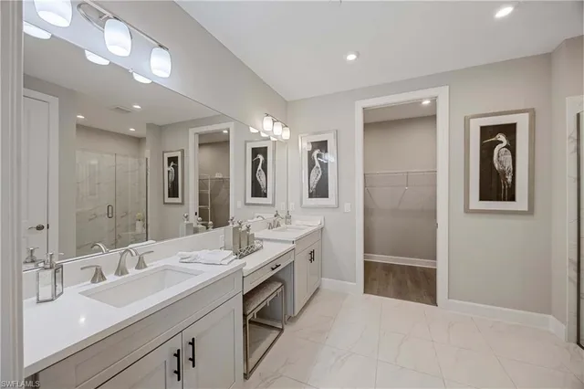 a bathroom with a double vanity sink mirror and
