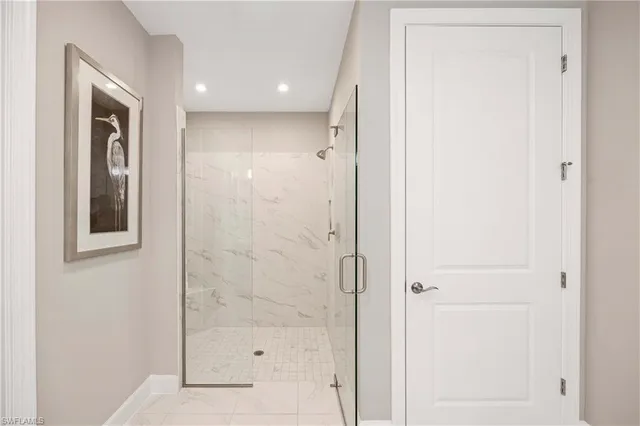 a bathroom with a glass shower door